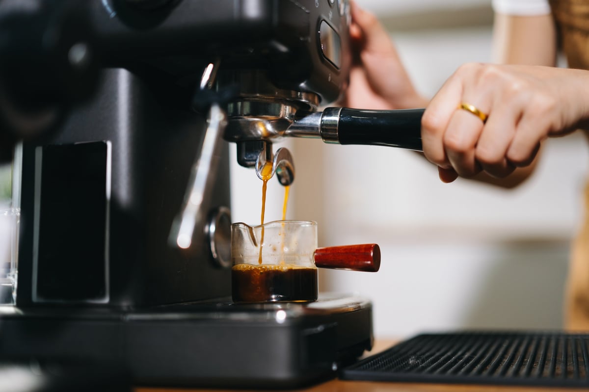 Close-up of espresso being pulled from an automatic machine